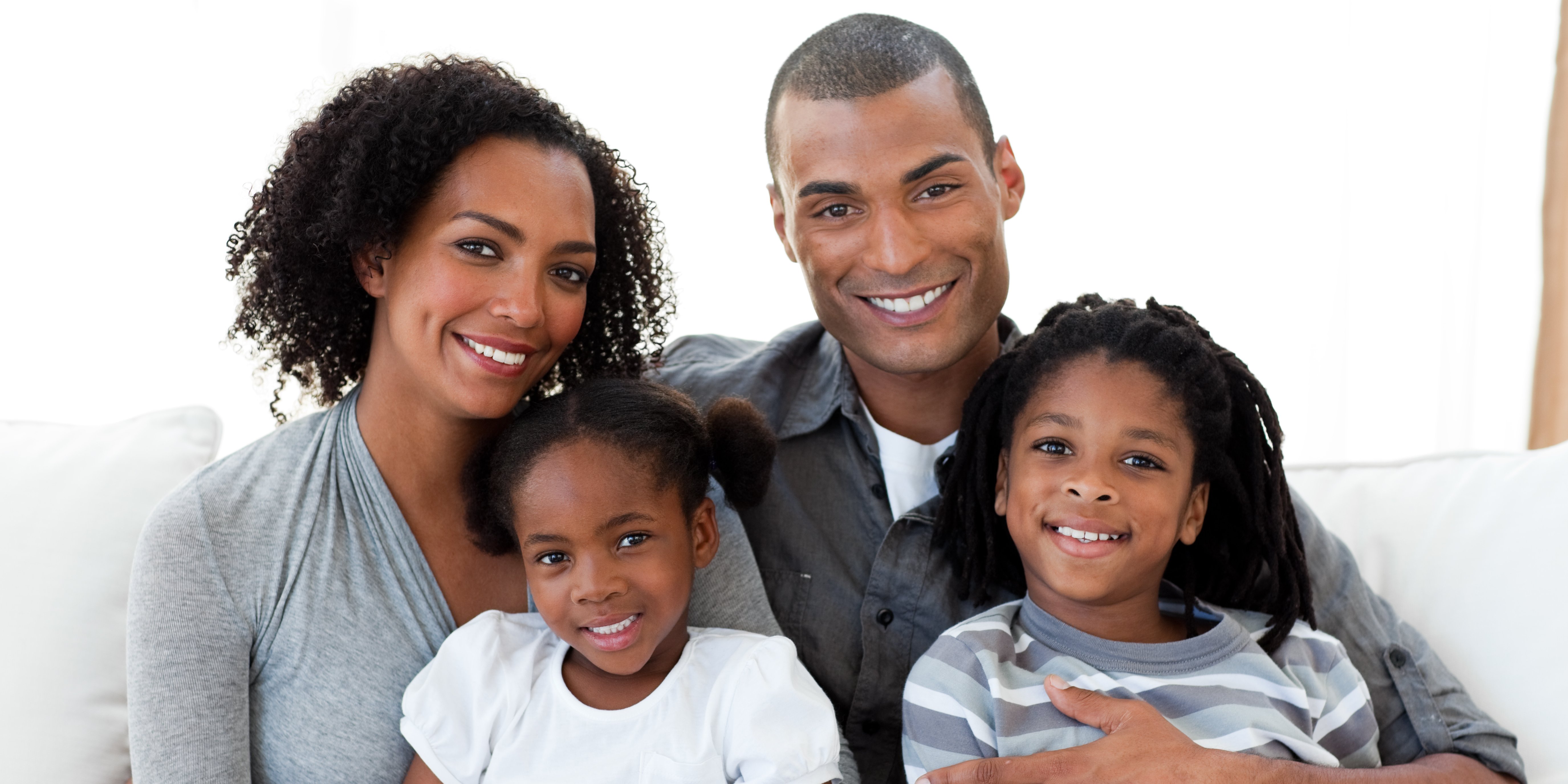 Man, woman, girl, and boy who are happy with the dentists and dental service at Family Dental Care in Temple Hills, MD