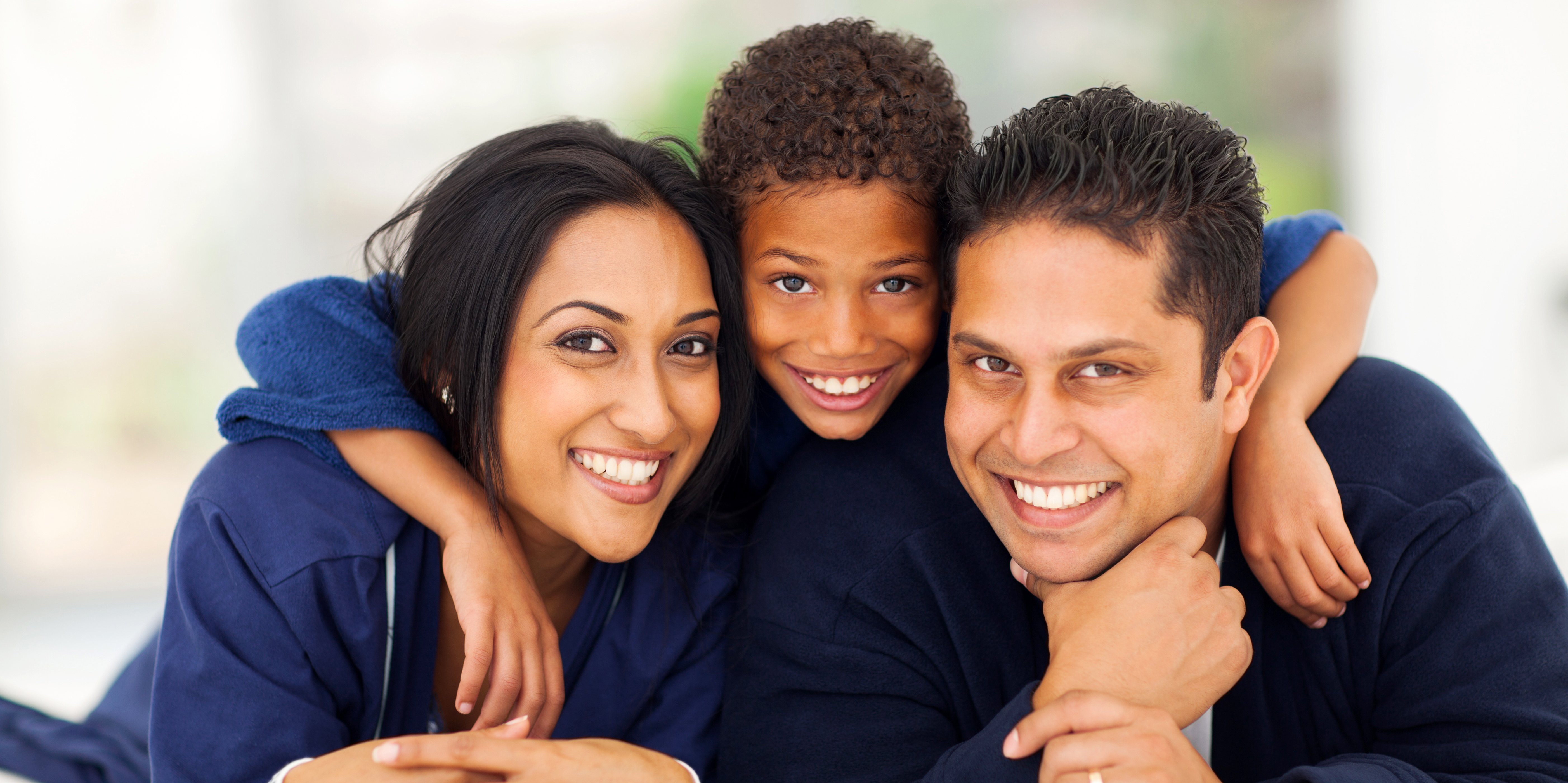 Woman, boy, and man who are happy with the dentists and dental service at Family Dental Care in Temple Hills, MD